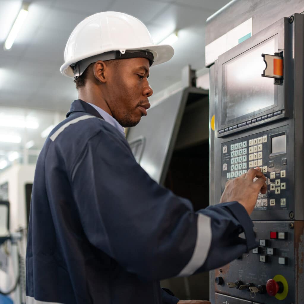 Worker operating cnc machine